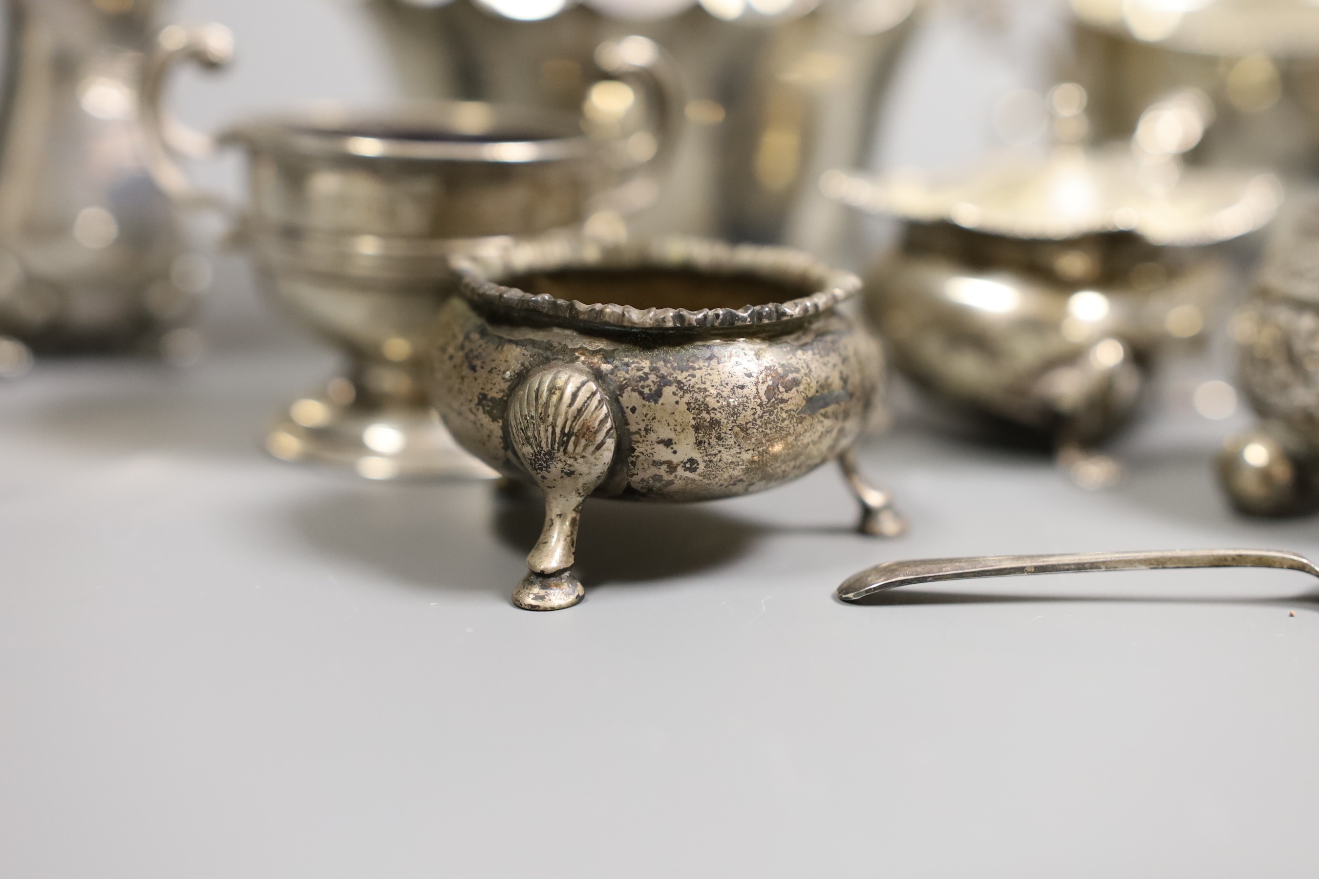 A small collection of mixed silver to include cased cutlery, a ladle, sauceboats, condiments, etc.
